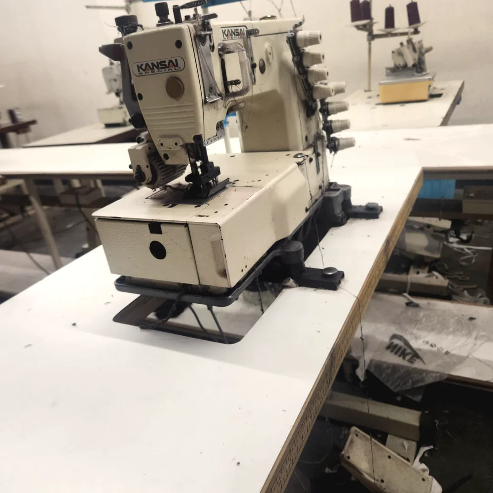 Multi-needle coverstitch machine set up for consistent, inspected seams on a partner factory line