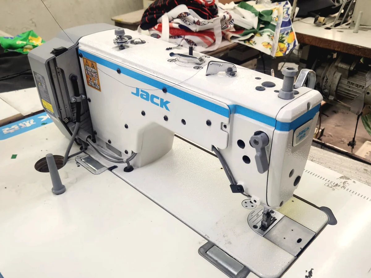 Industrial lockstitch sewing machine on a clean production table